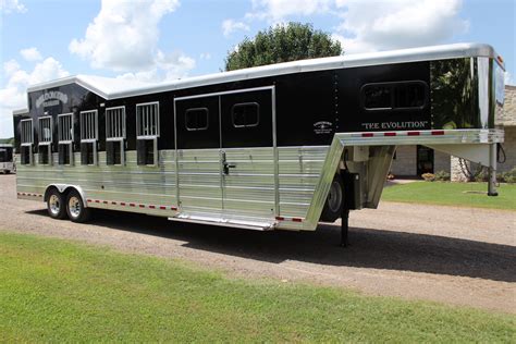Bloomer trailers - The interior of this trailer features a maple wood finish and includes a sleeper sofa in the 12' slide out w/ 6.0 fridge 6. gallon hot water heater, corner booth w/ moveable table. 32" TV, satellite, WiFi, Stereo, DVD 2- A/C's, furnace, TV in bed area, w/ storage and generator start button, hat racks, 2-burner cook top, convection microwave, single sink.